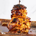 A stack of chicken on a spit.
