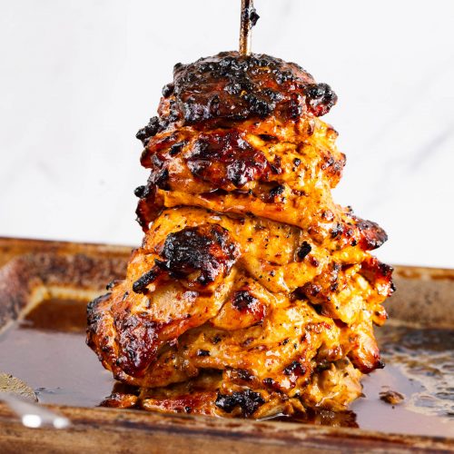 A stack of chicken on a spit.