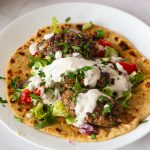 Flatbread and kofta kebabs with salad,