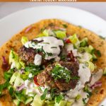 Pinterest image for kofta kebabs with salad and tahini.