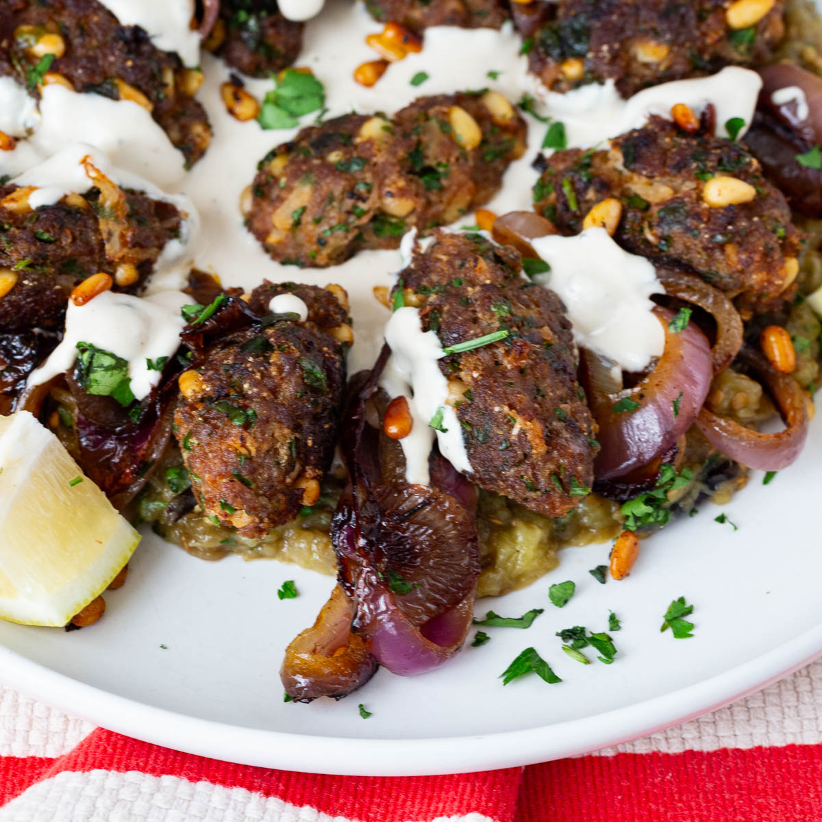 A platter with beef kebabs on a platter.