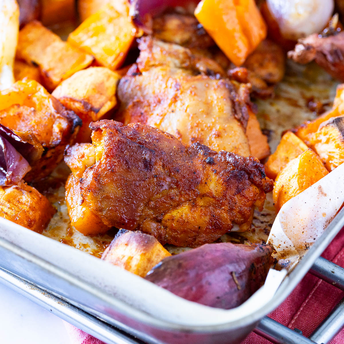 A sheet pan with chicken and veggies.