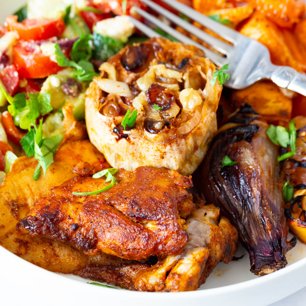 A plate with chicken and veggies.
