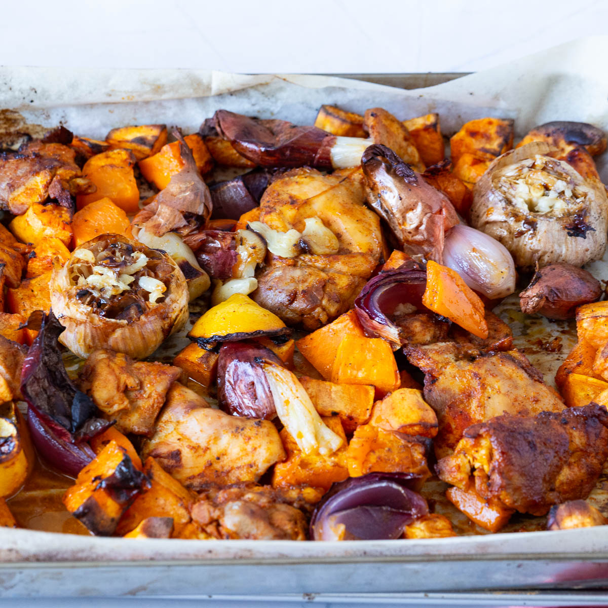 A sheet pan with chicken and veggies.
