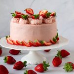 A frosted cake on the cake stand.