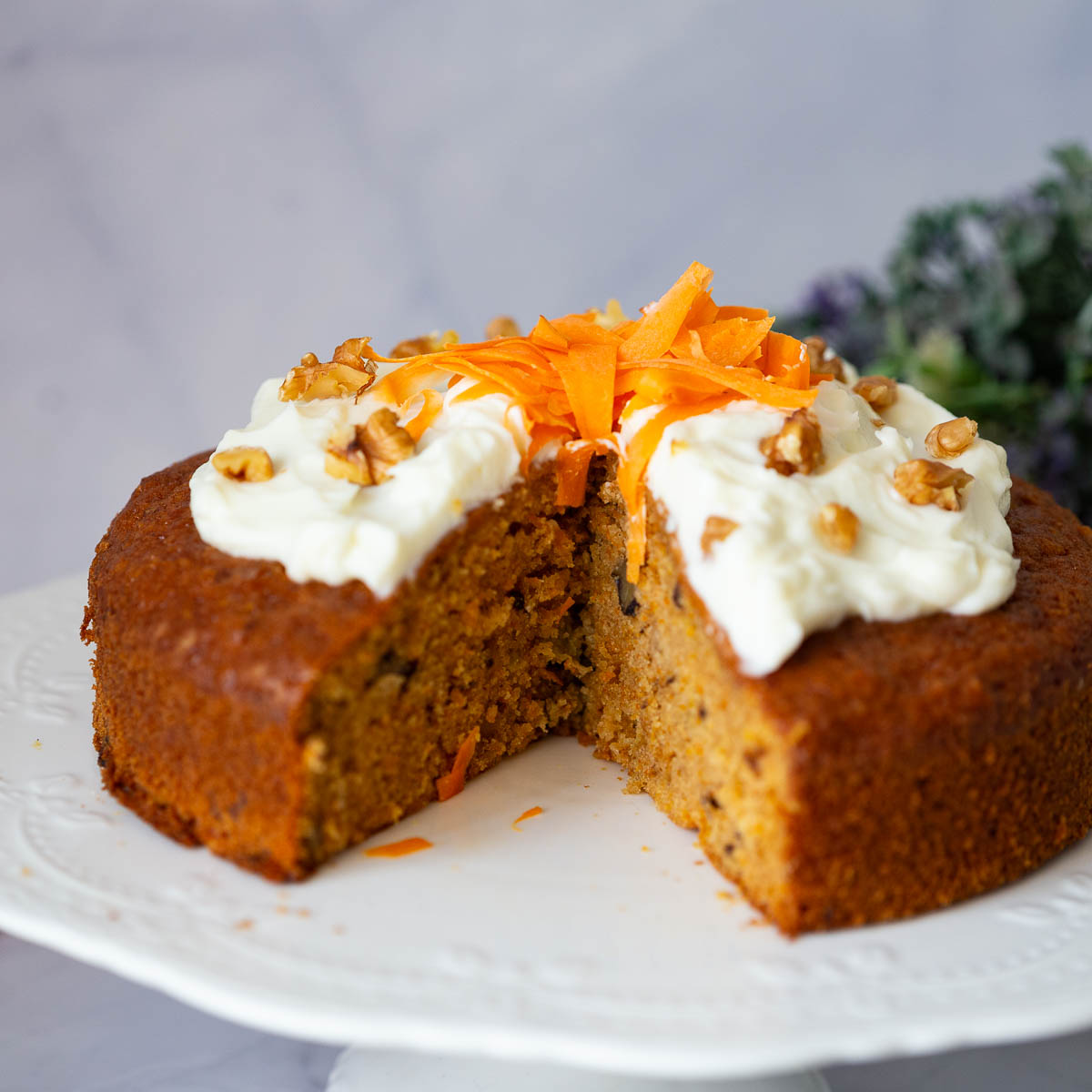 Carrot cake with cream cheese glaze on the table.
