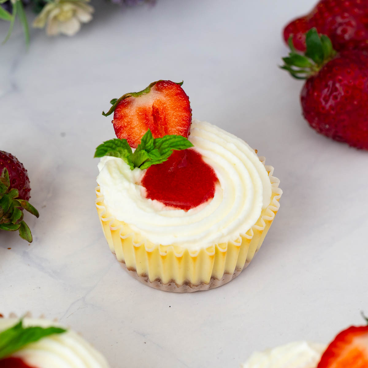 Baked strawberry cheesecakes on the table.