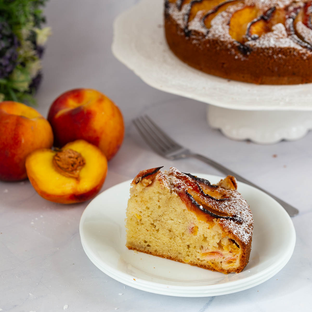 A sliced peach cake on the plate.
