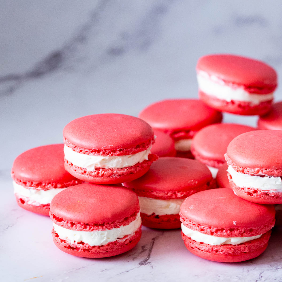 Red raspberry macarons on the table.