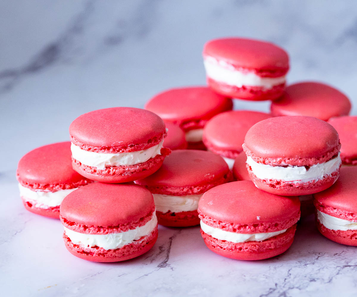 Red raspberry macarons on the table.
