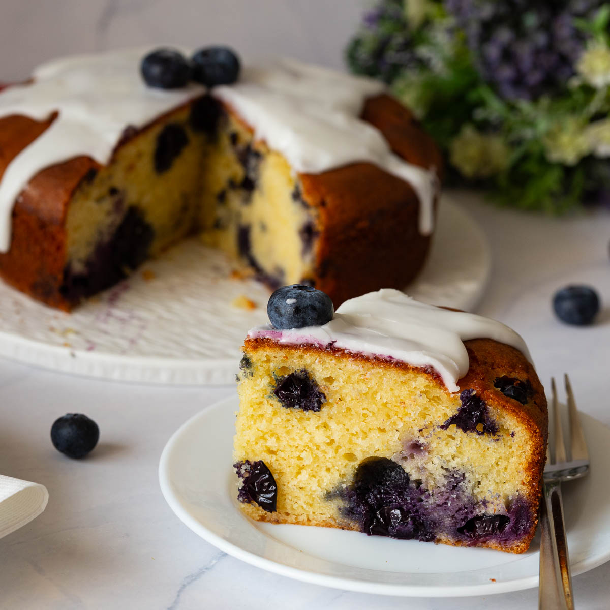 A sliced blueberry yogurt cake on the plate.