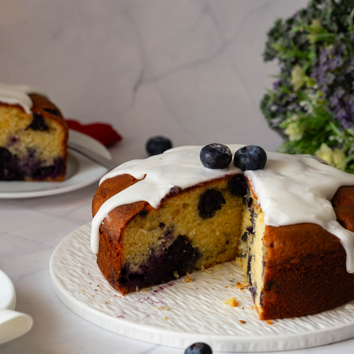 A sliced blueberry yogurt cake on the plate.