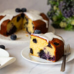 A sliced blueberry cake on the plate.