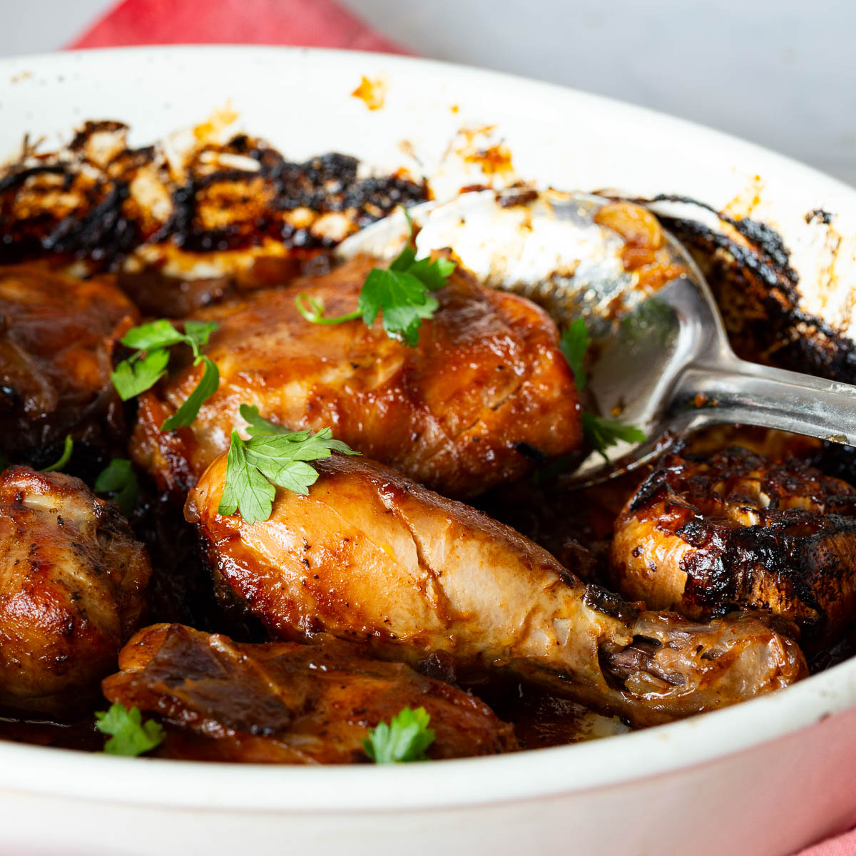 A baking dish with chicken and hot honey sauce.