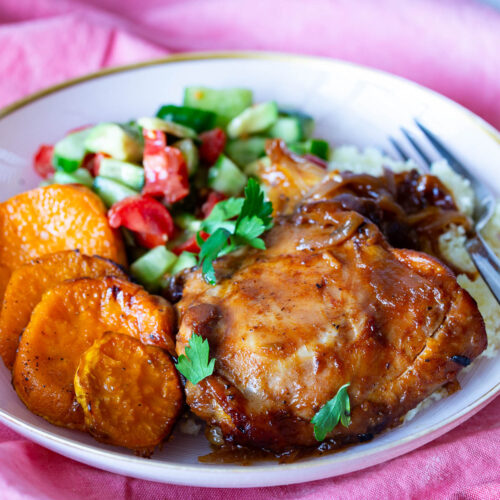 A plate with hot honey chicken salad and sweet potatoes.