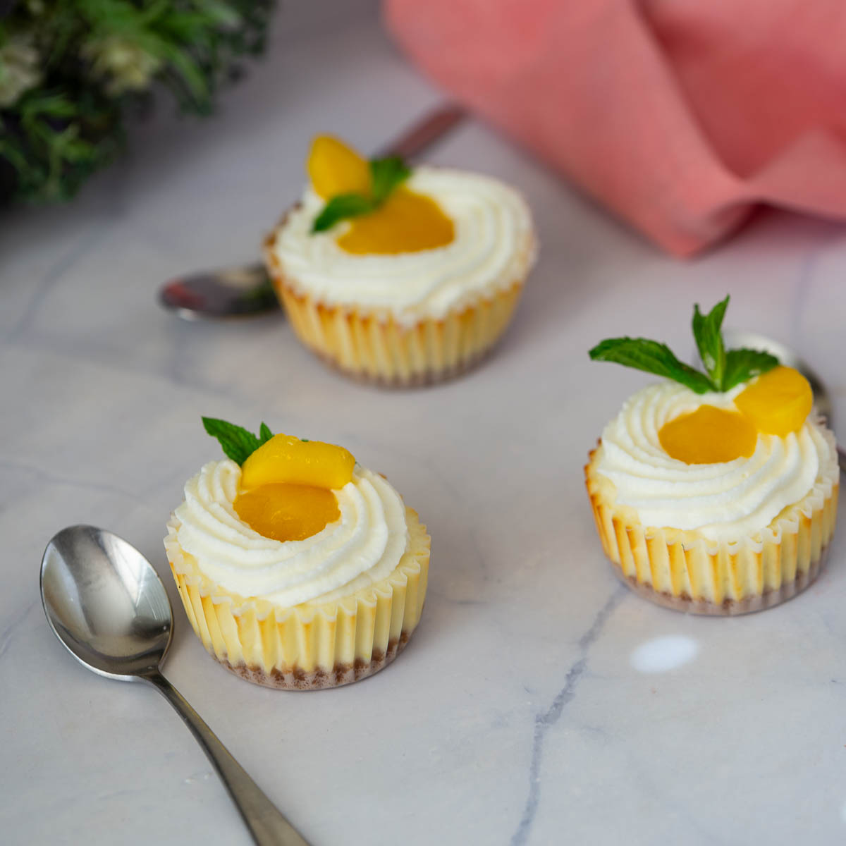 Baked mango cheesecakes on the table.