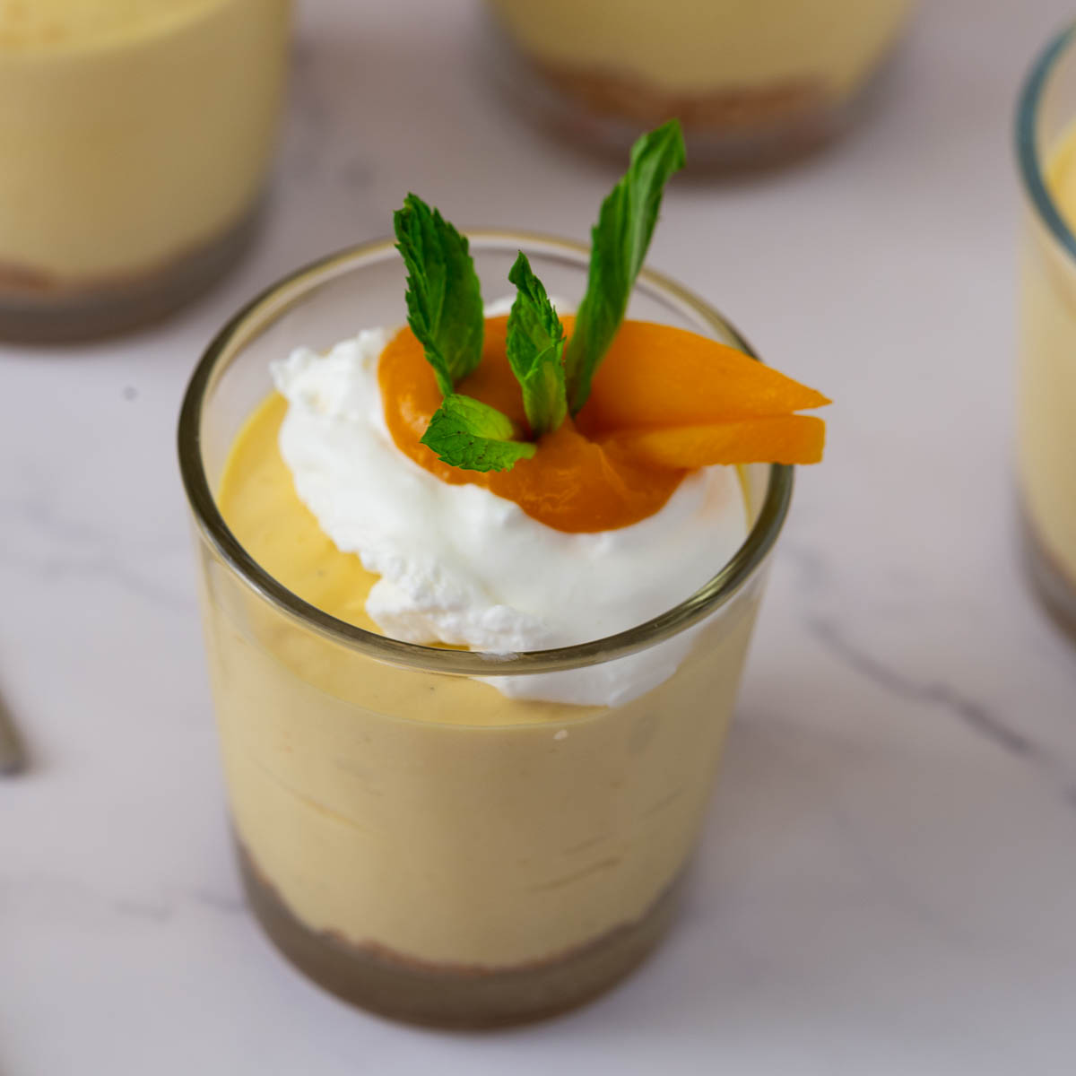 A short cup with mini cheesecake cups.