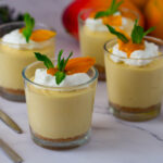 Short glasses with mini mango cheesecakes.