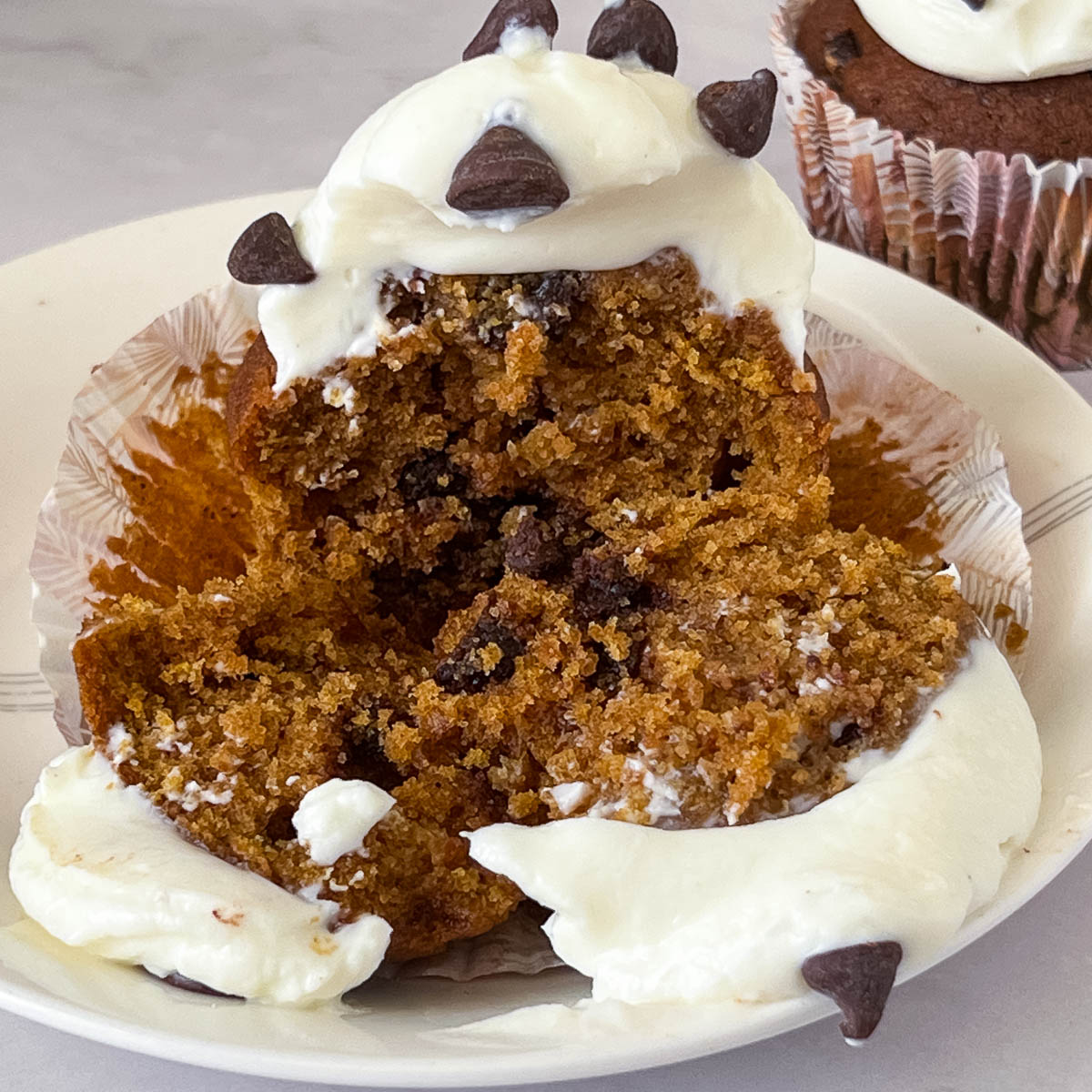 A sliced pumpkin cupcake on the table.