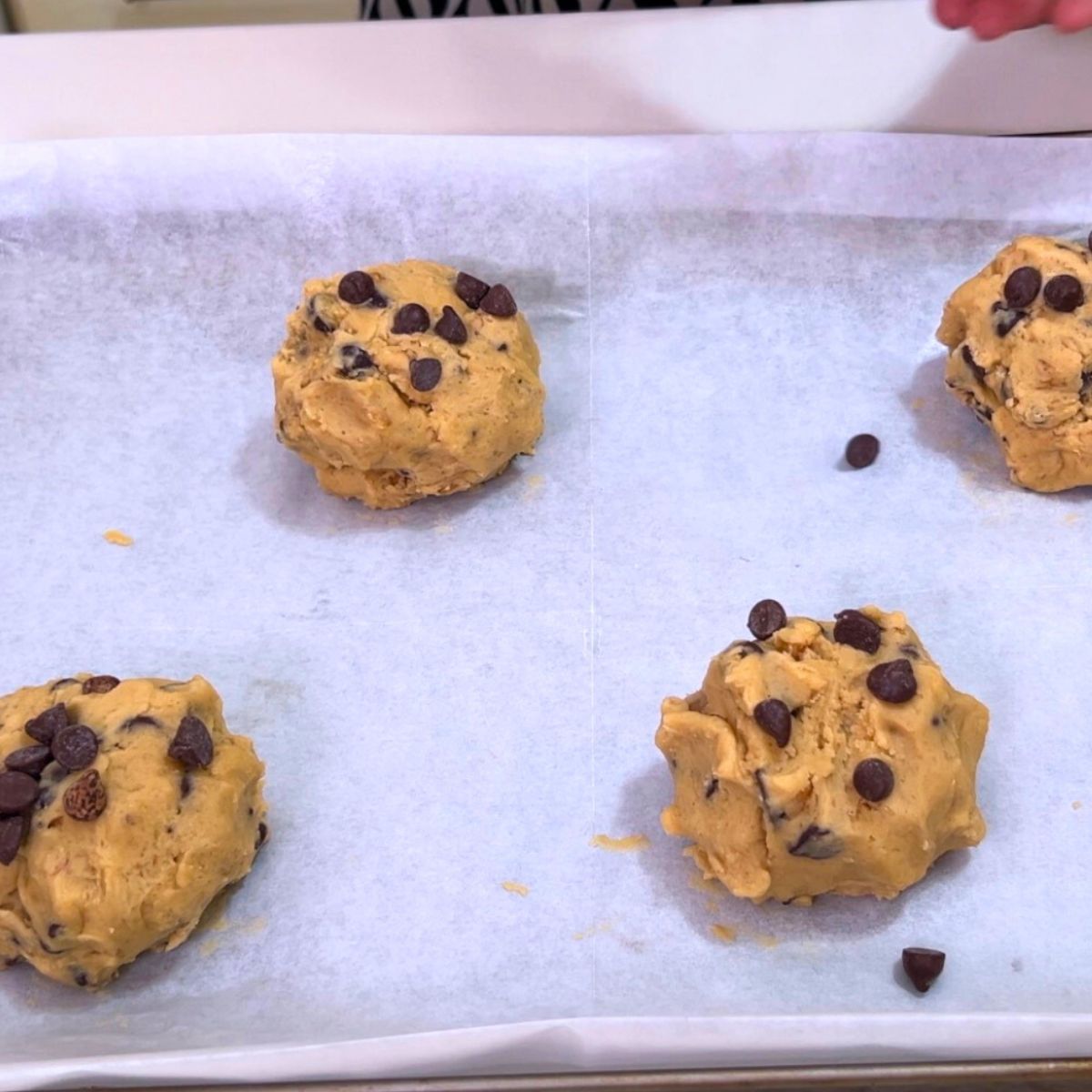 A baking tray with chocolate chip cookies.