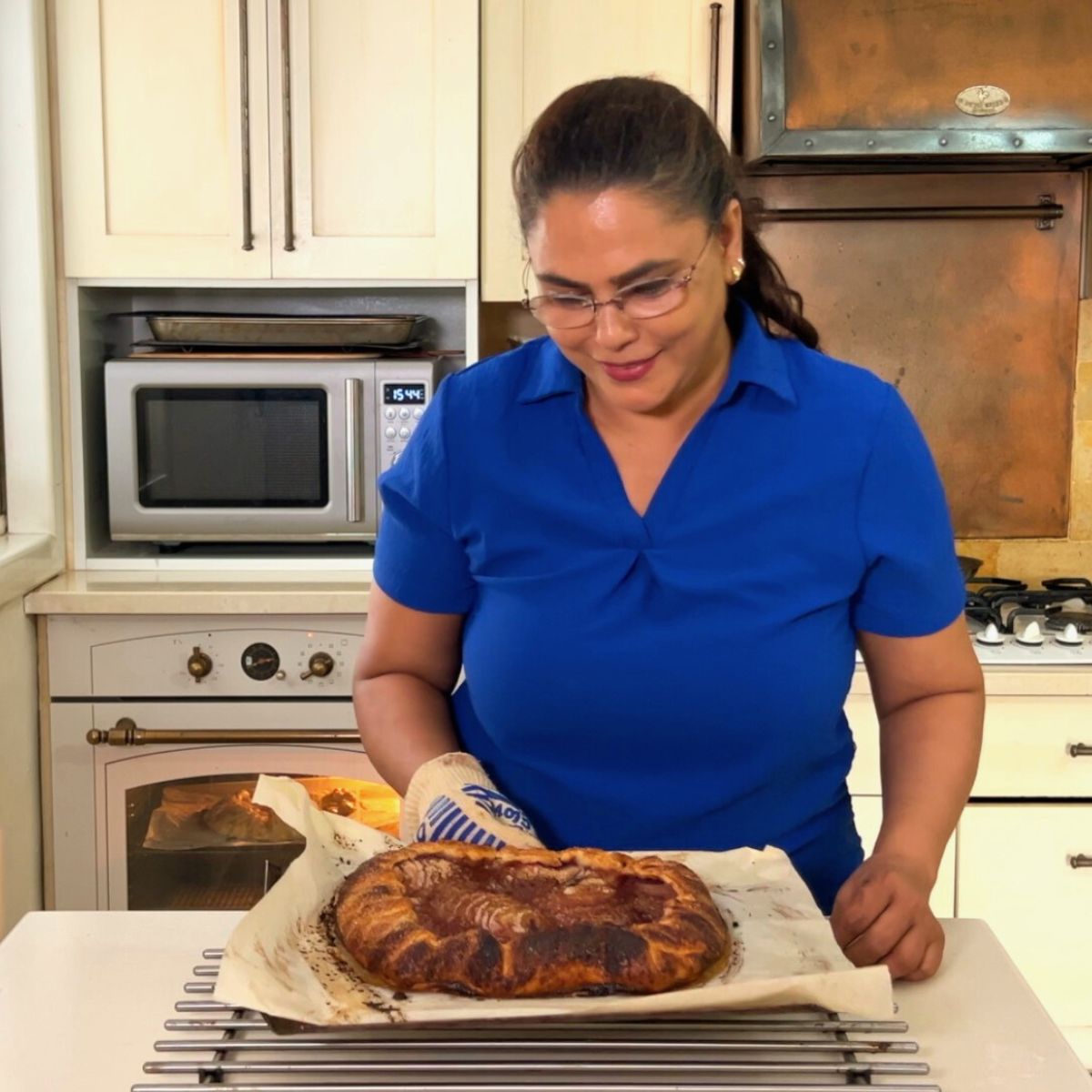 Veena Azmanov with dessert out of the oven.