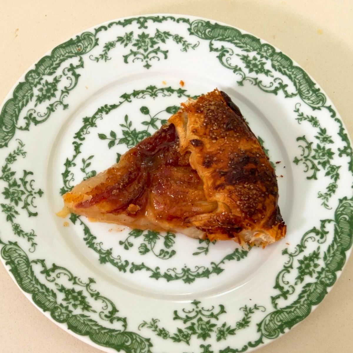 A plate with slice of peach galette.
