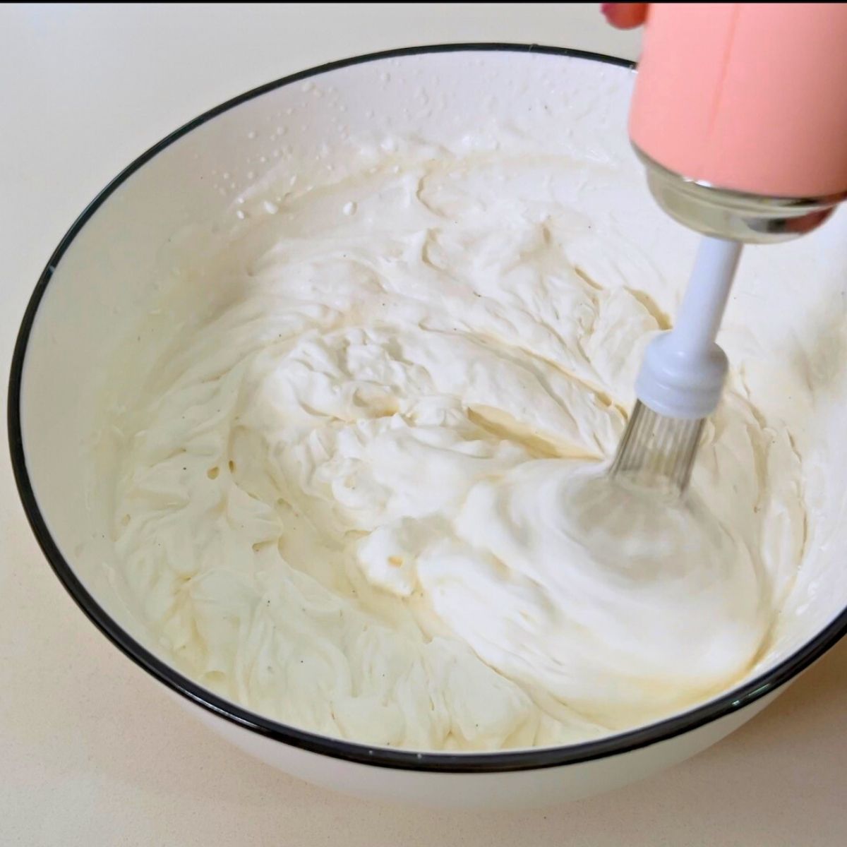 Bowl making cream cheese whipped cream.