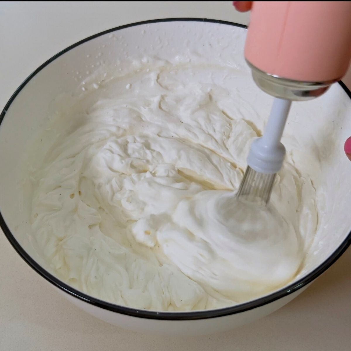 A bowl with cream cheese frosting.