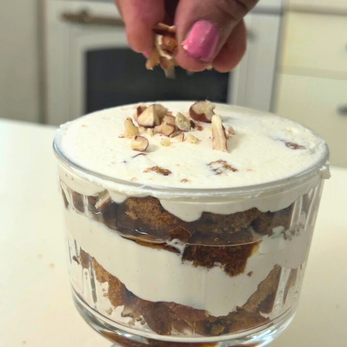 Frosting the pumpkin trifle in dessert cups.