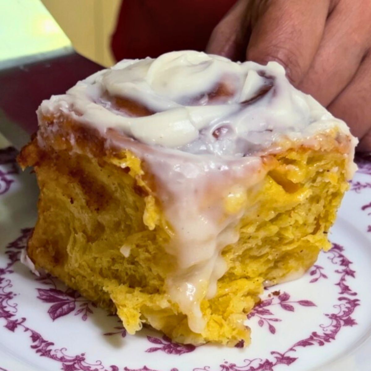 A slice of pumpkin cinnamon roll.