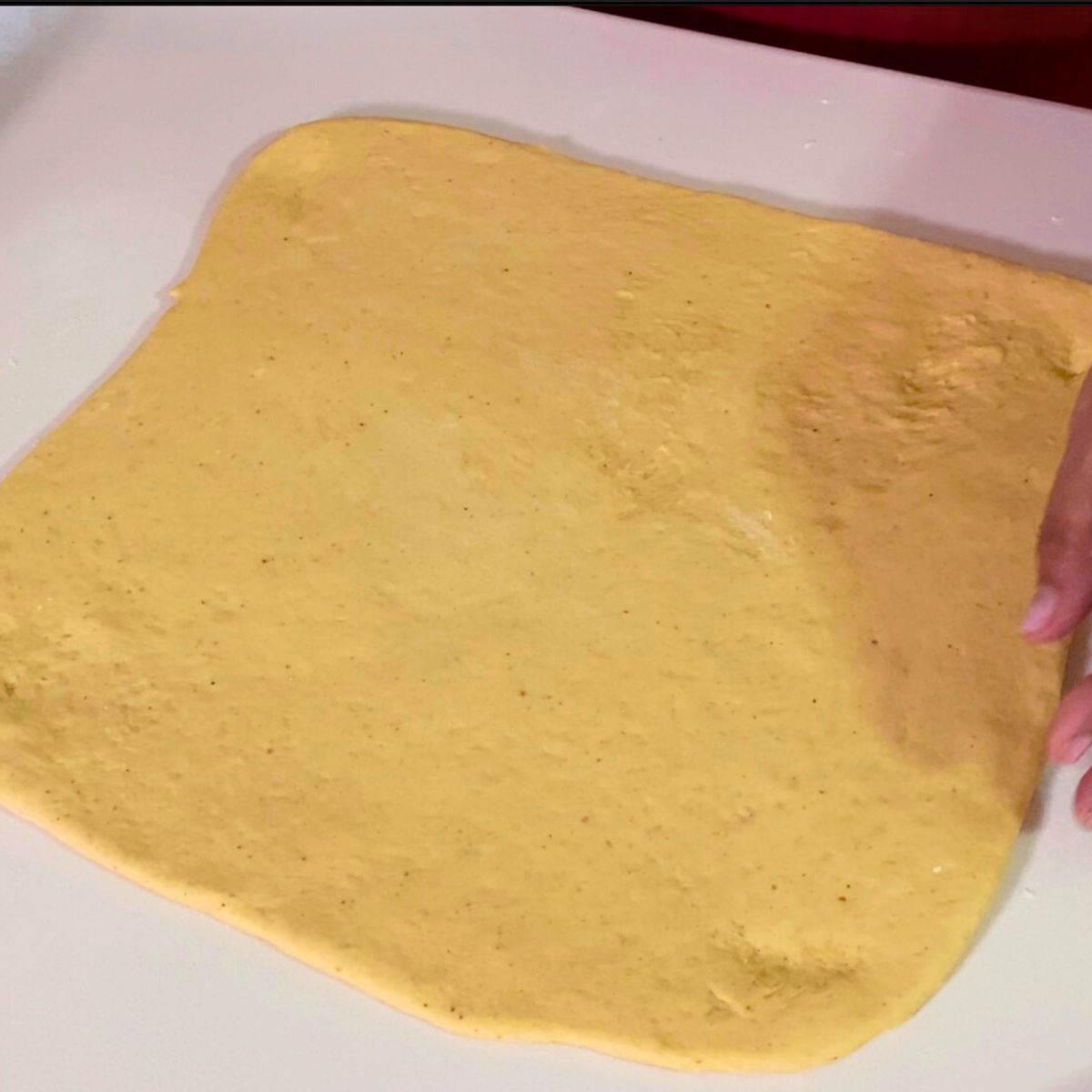 Pumpkin dough rolled out into a rectangle.