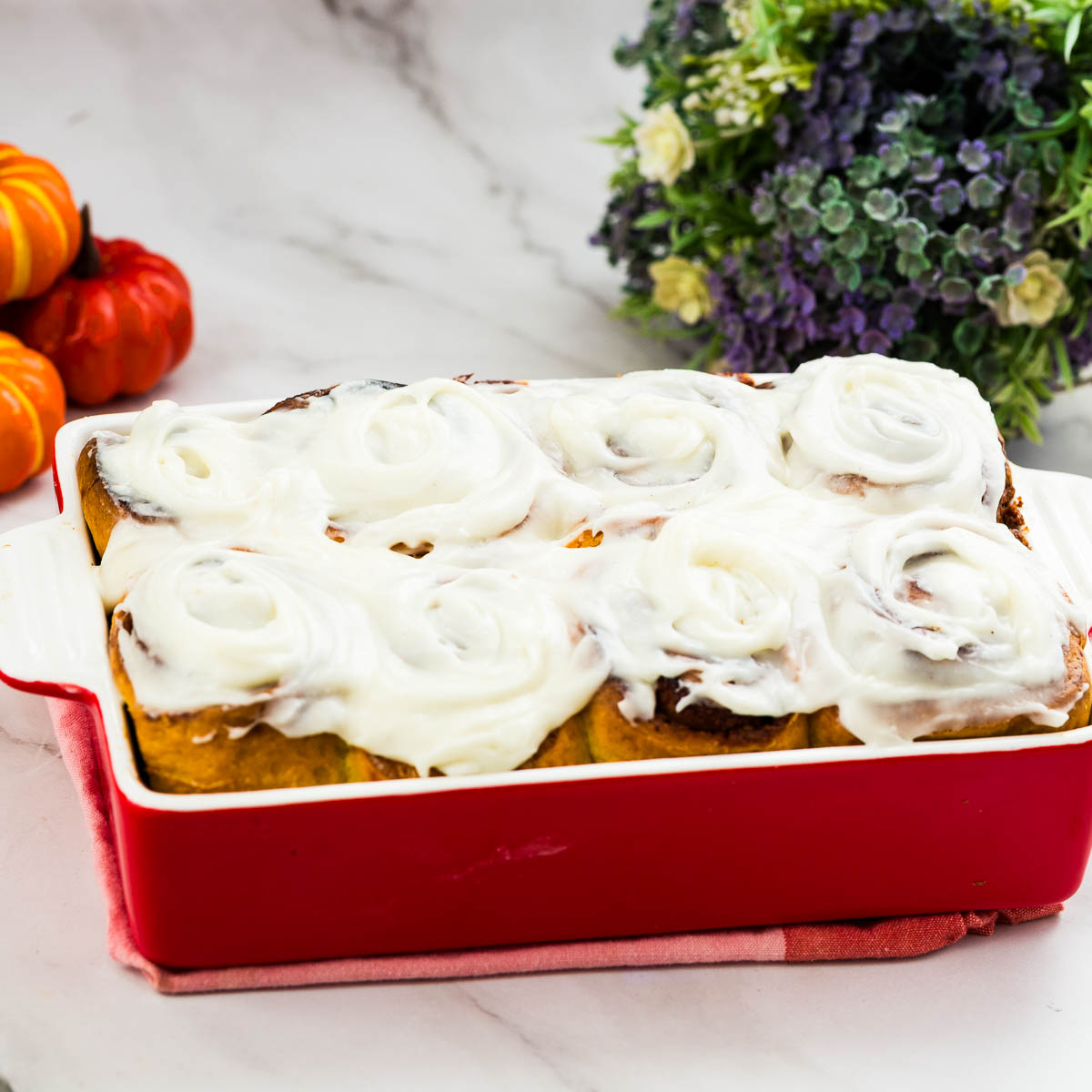 A baking dish with pumpkin cinnamon rolls.