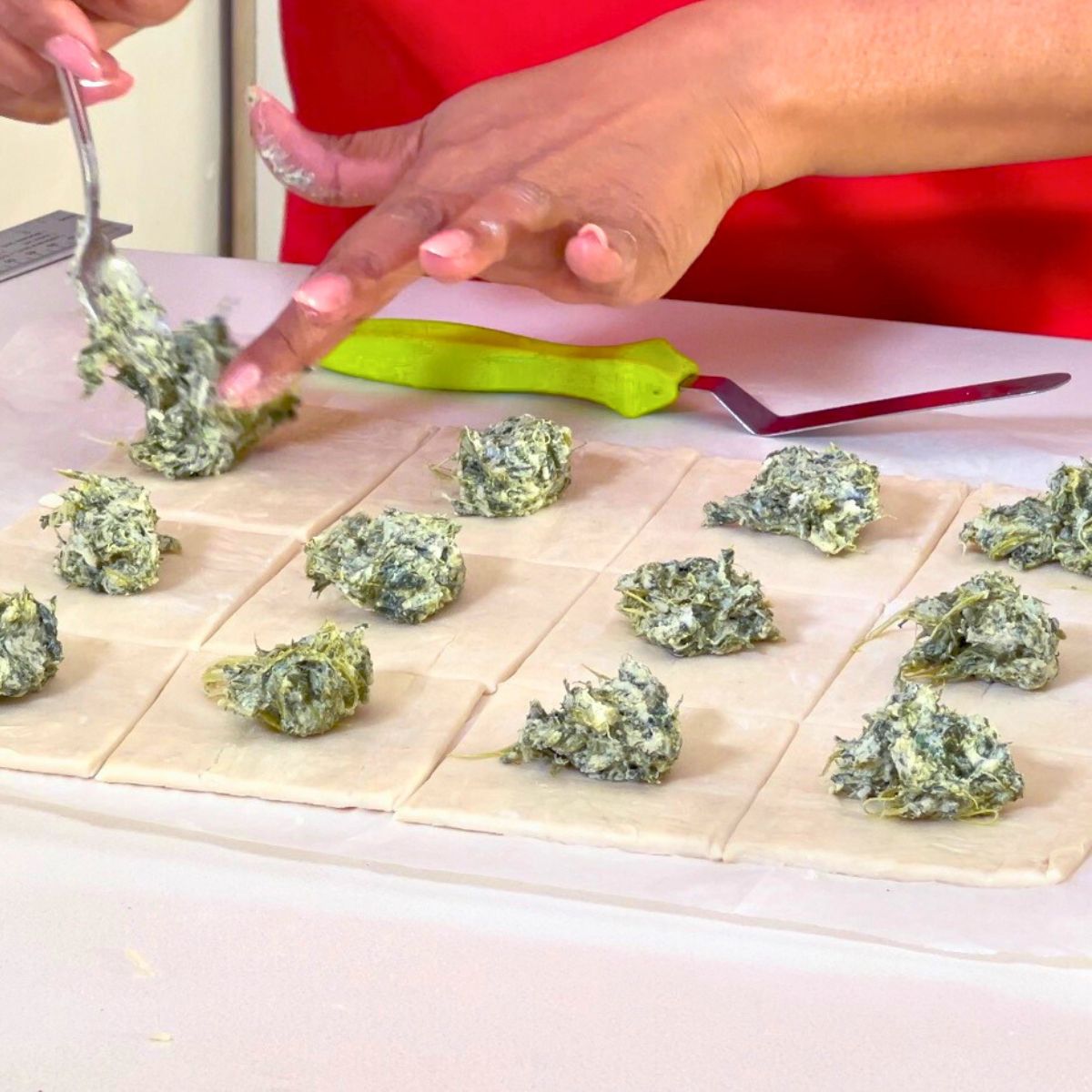 Filling the puff pastry appetizers.