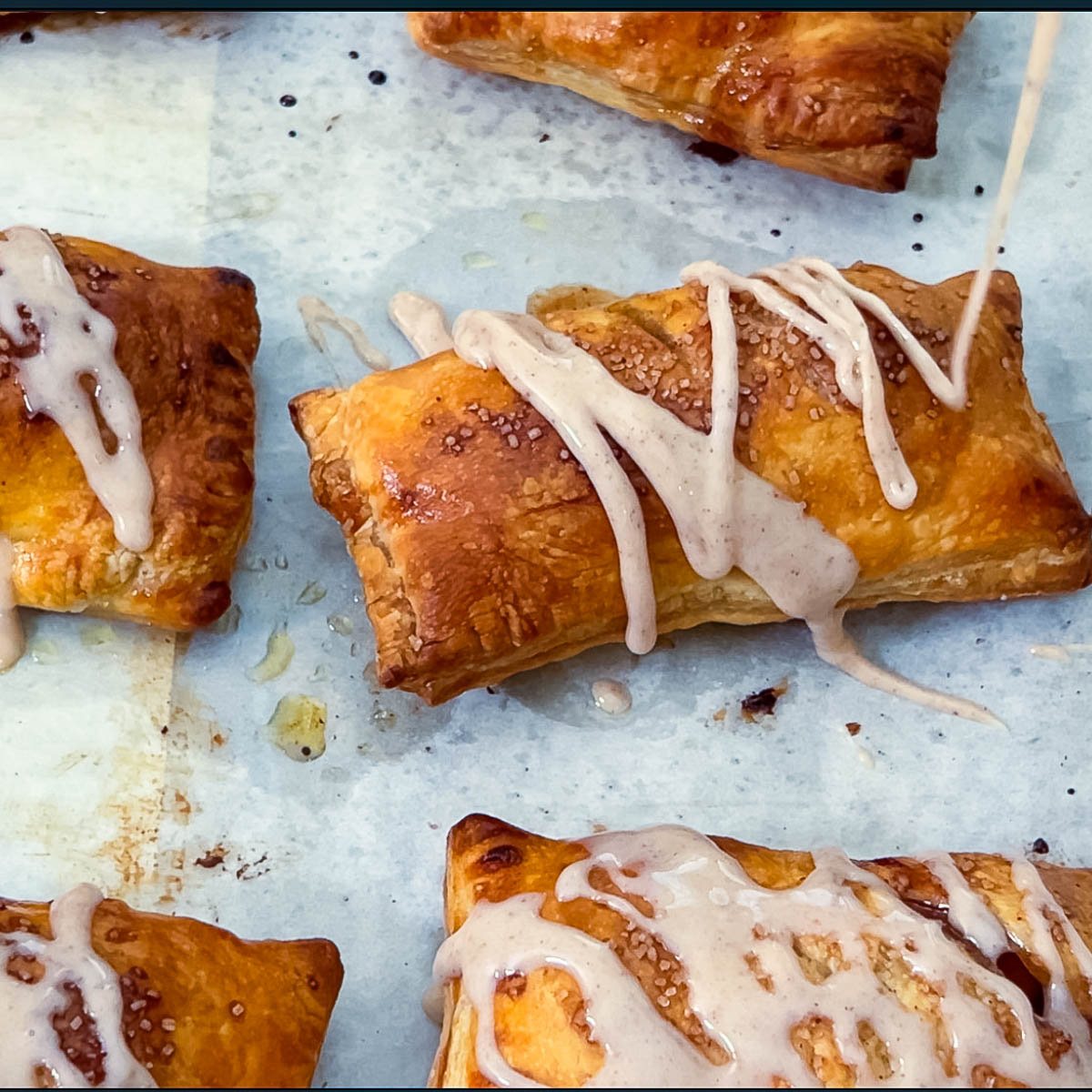 Drizzling cinnamon glaze on the pastries.