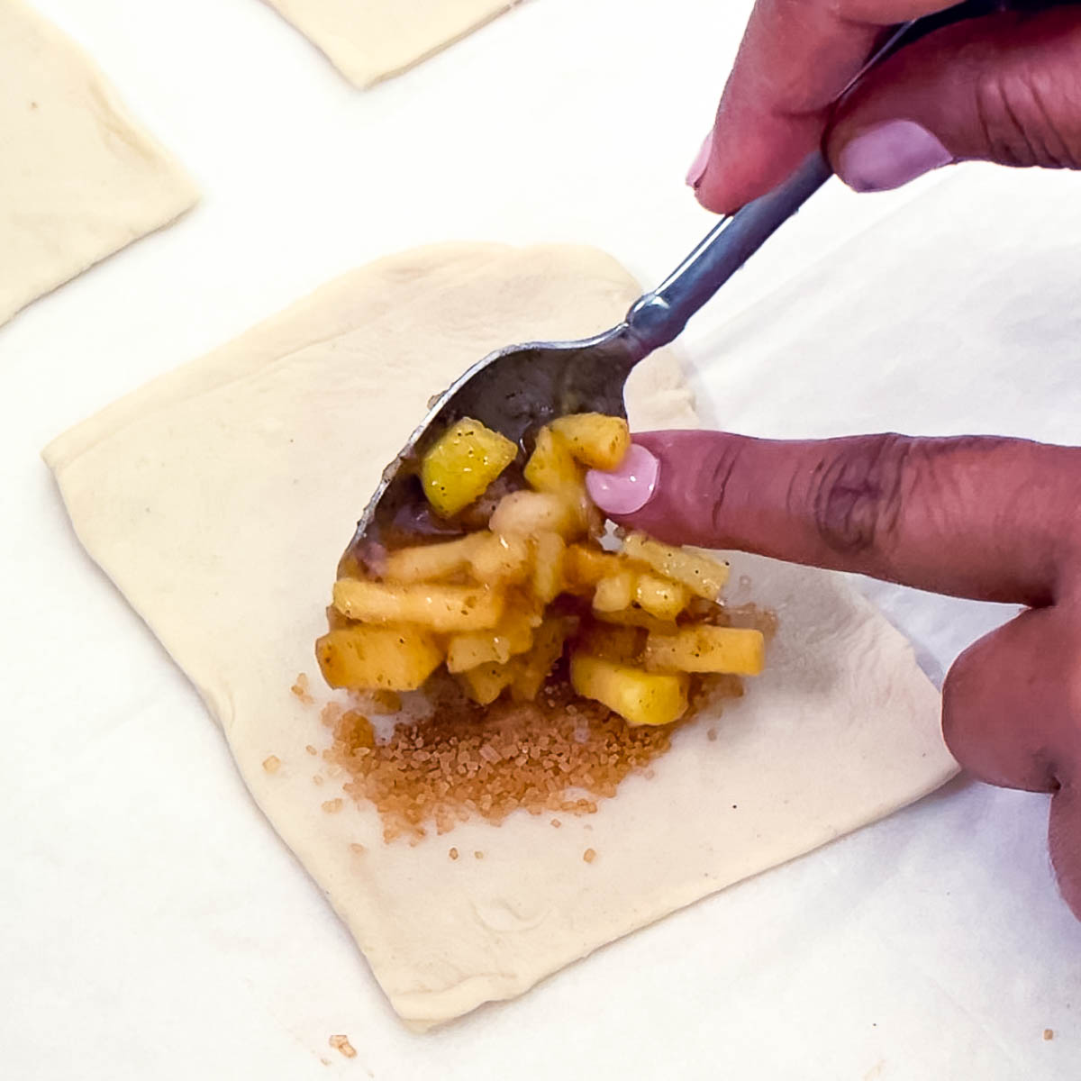 Filling the apple puffs with apple filling.