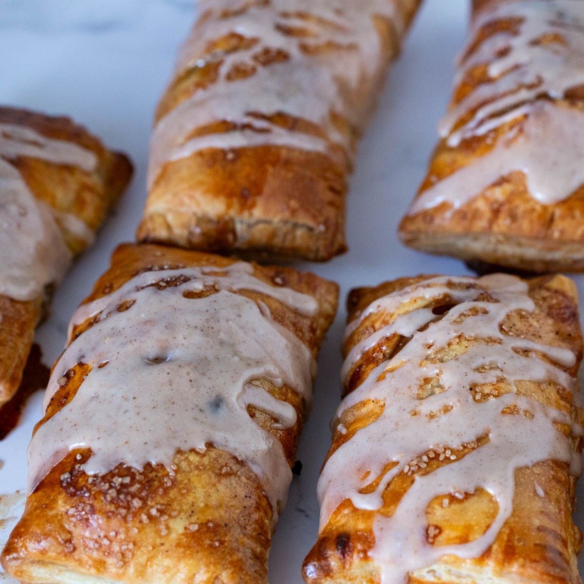Baked puff pastry turnovers on the tray.