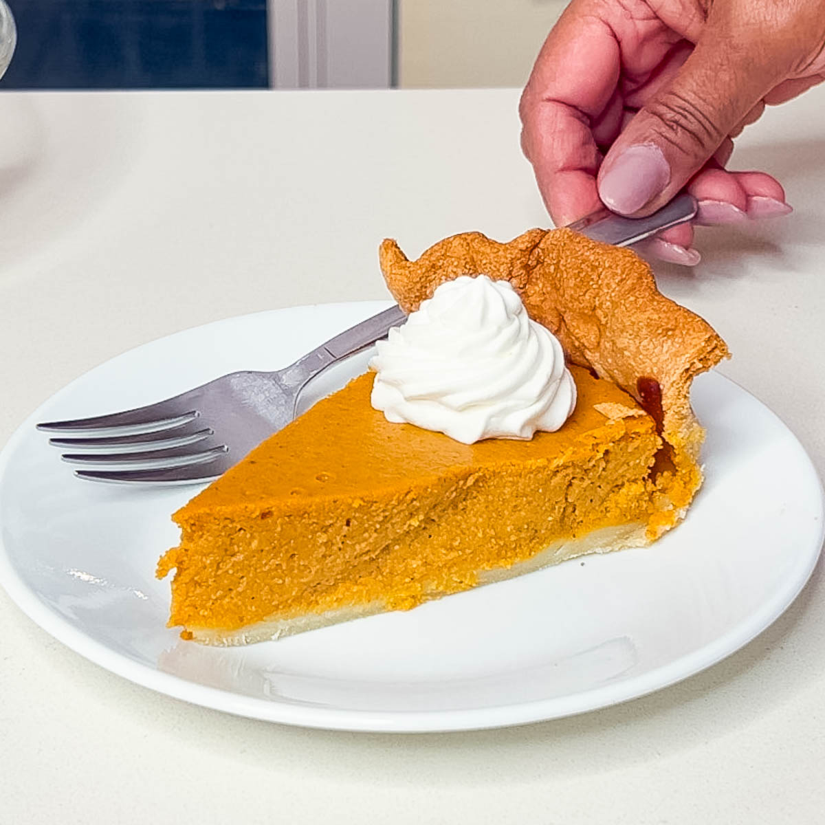 Slice of pumpkin pie with whipped cream.