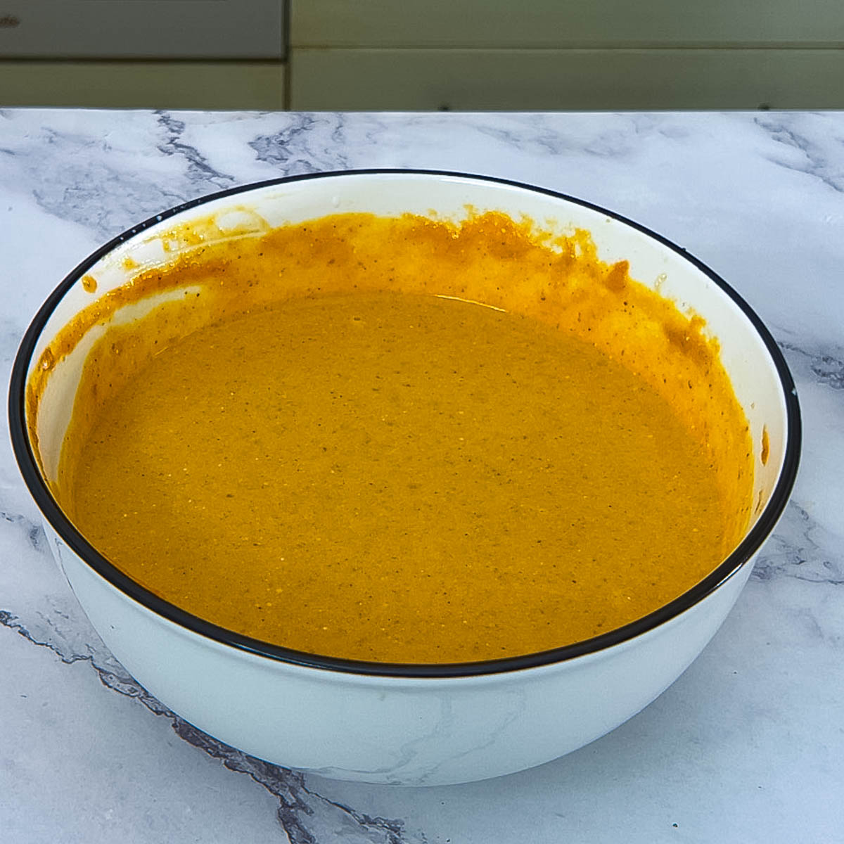 A bowl with pumpkin pie filling.