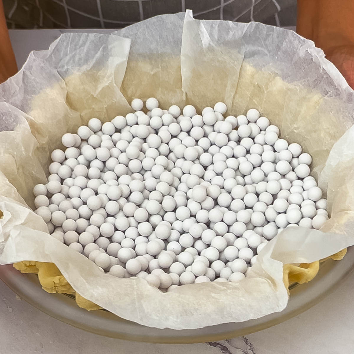 Partially baking a pie crust with baking beans.