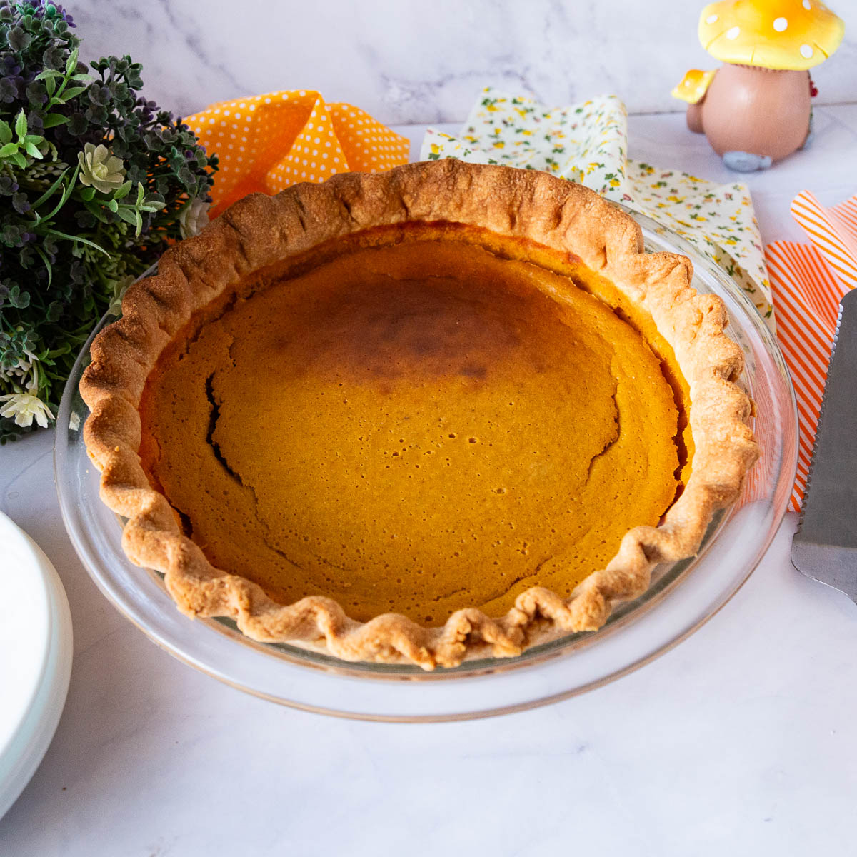 A baked pumpkin pie on the table.
