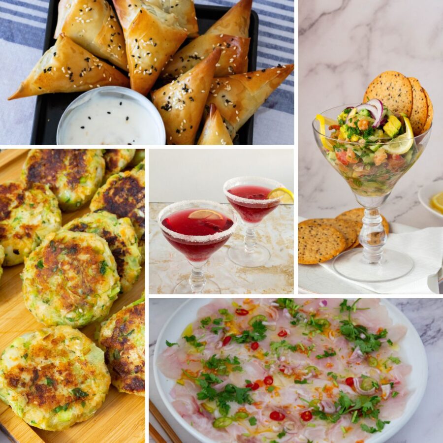 A selection of New Year’s appetizers and festive cocktails arranged on a table for a holiday celebration.
