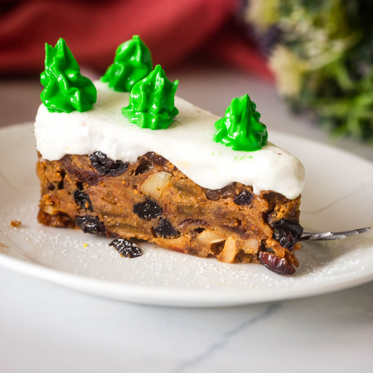 A slice of fruitcake on the plate.