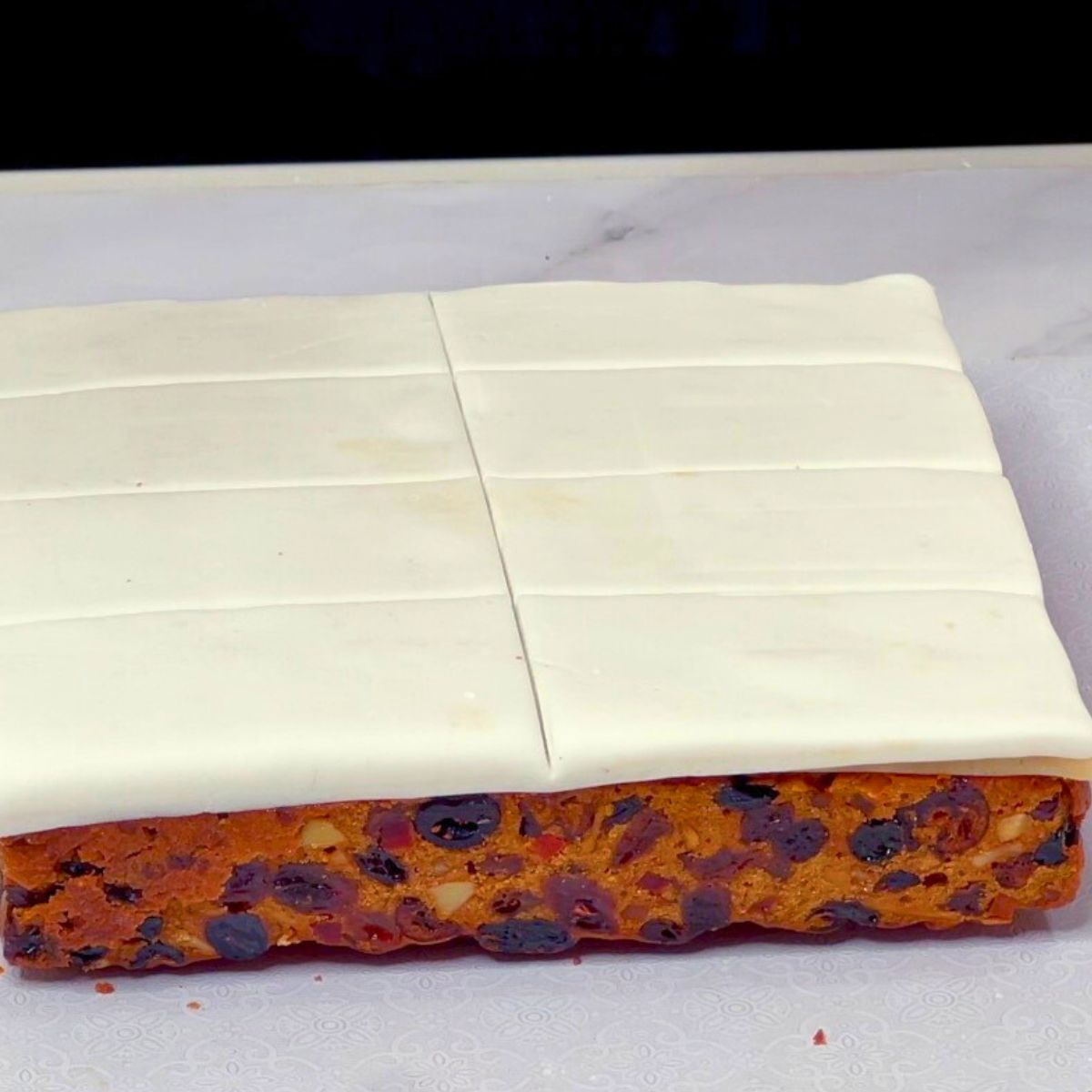Fruit Cake topped with marzipan and fondant.