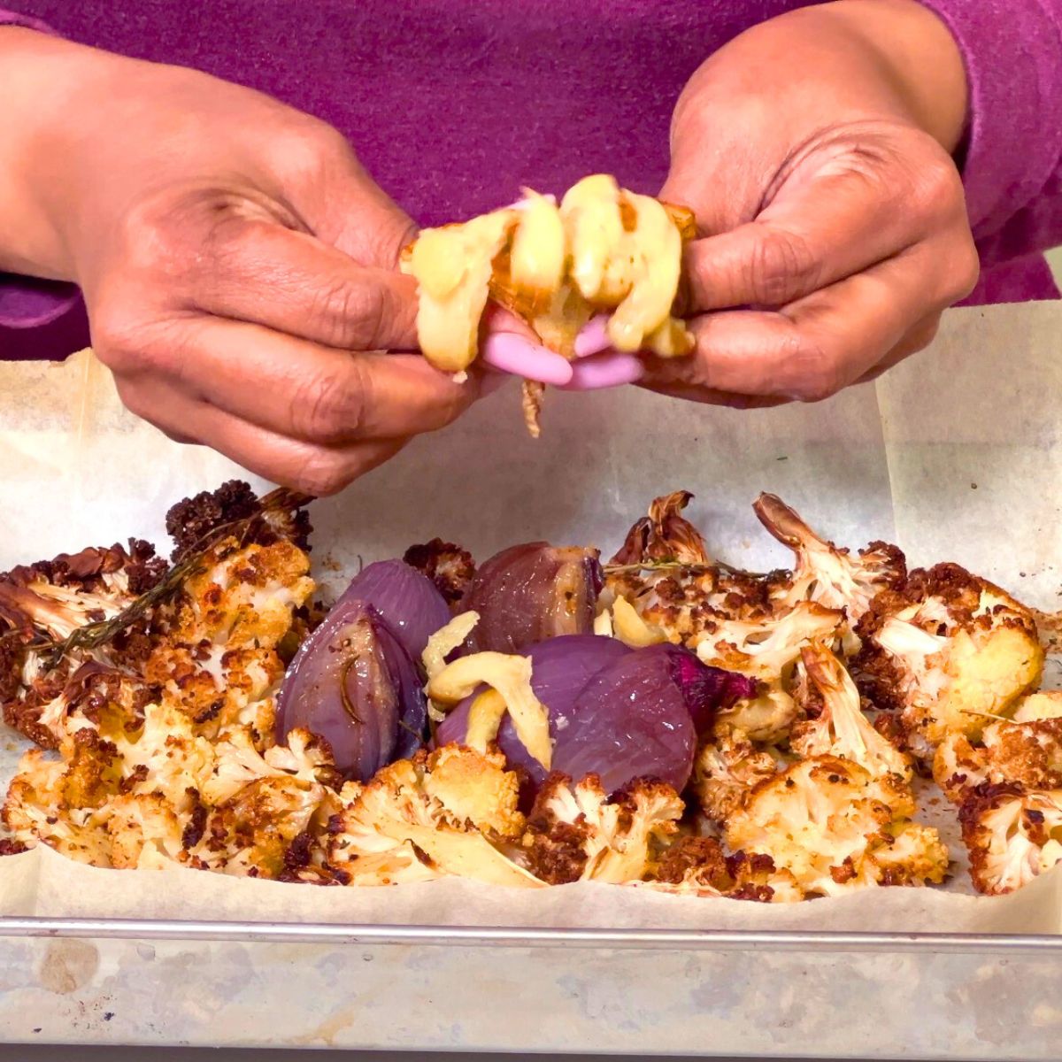 A baking tray with roasted cauliflower and veggies for soup.