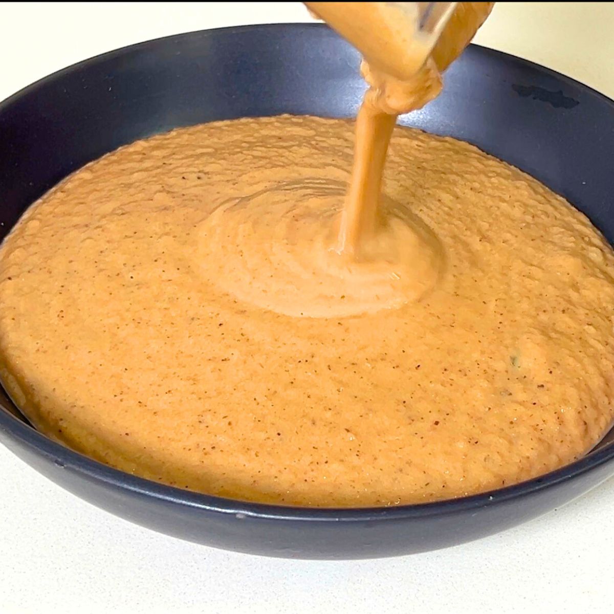 Pouring the blended soup in a bowl.