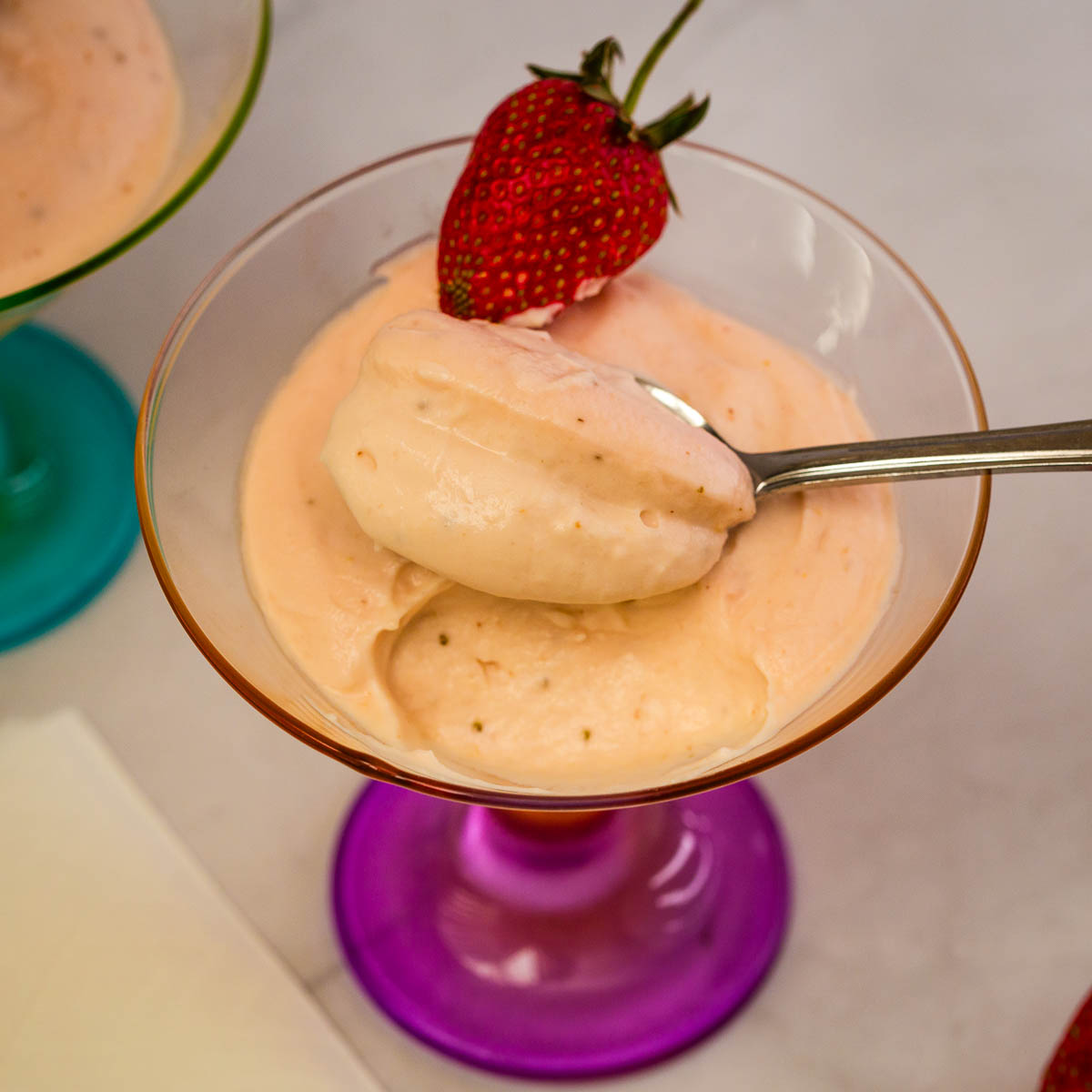 Pink strawberry mousse in martini glasses.