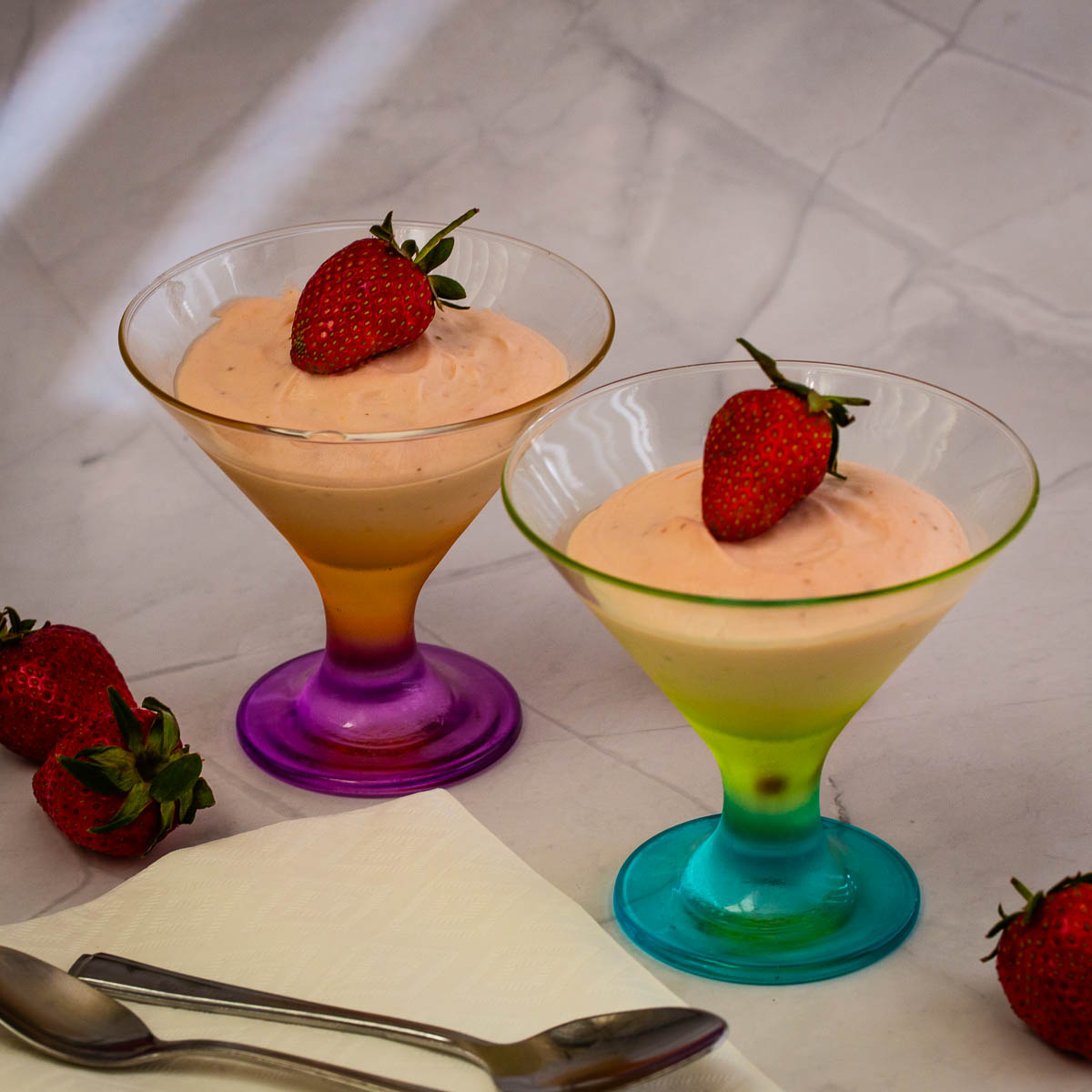 Two martini cups with strawberry mousse.