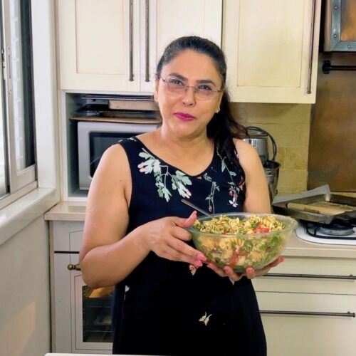 Veena Azmanov with a bowl of pasta salad.
