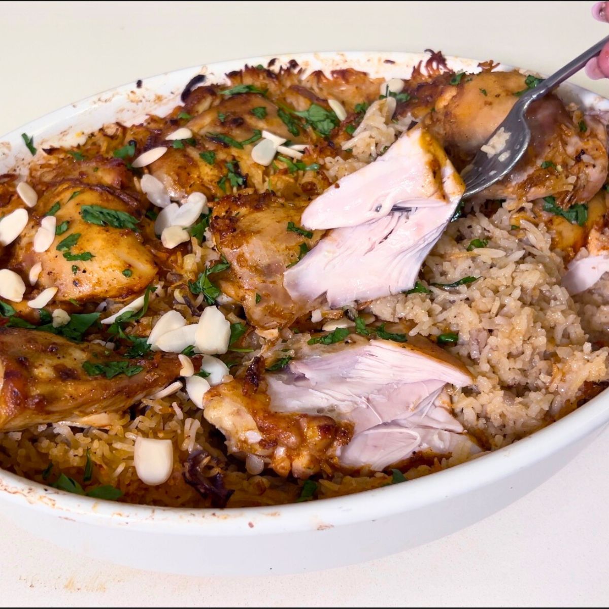 A baking dish with chicken and rice casserole.