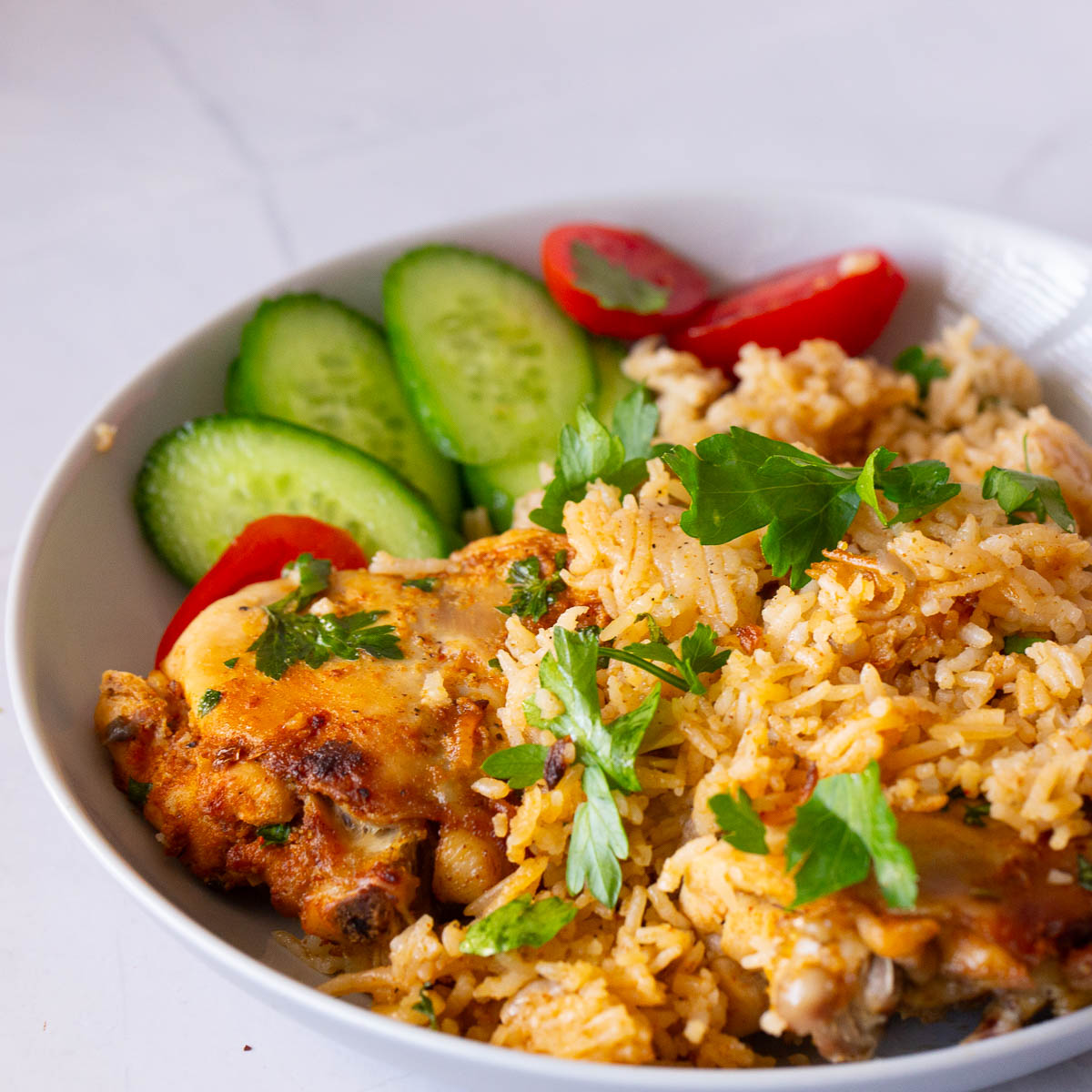 A white plate with chicken and rice.